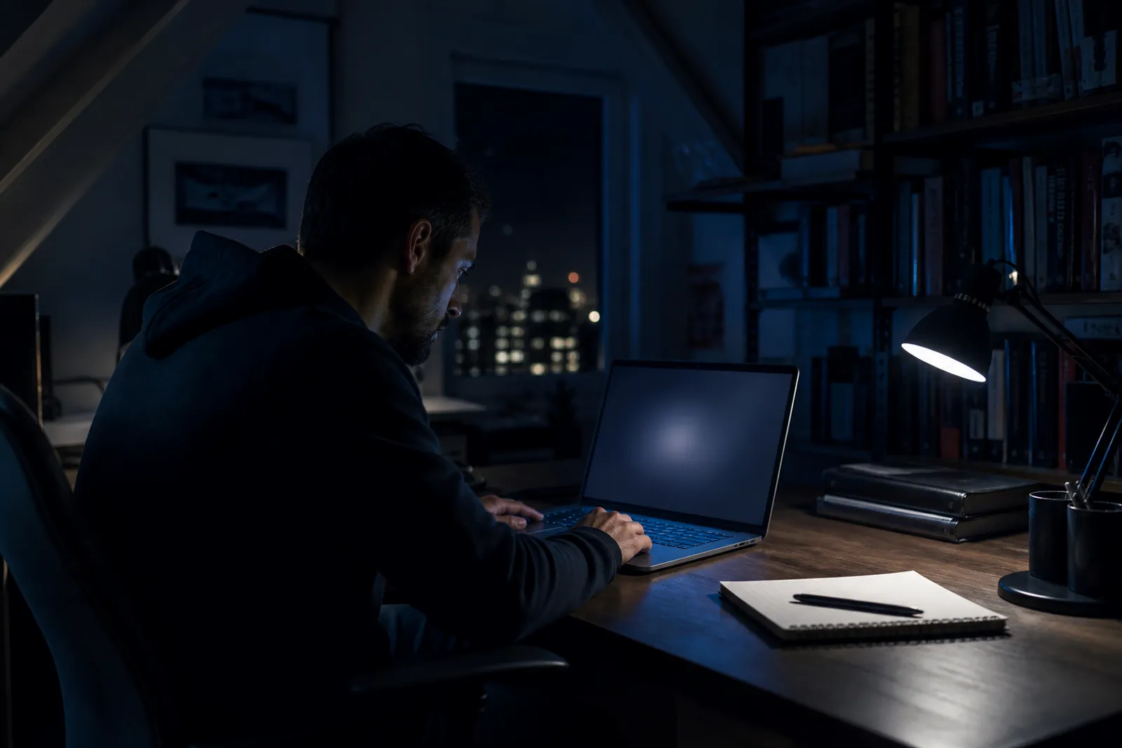 A user exploring the Ahmia search engine for .onion sites in a low-lit room.